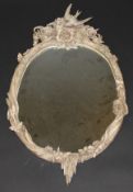 A carved and painted framed limewood wall mirror with bird, mouse, rabbit and foliate decoration,