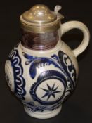 An 18th Century German beer flagon with star and floral and foliate sgraffito and blue glazed