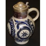 An 18th Century German beer flagon with star and floral and foliate sgraffito and blue glazed