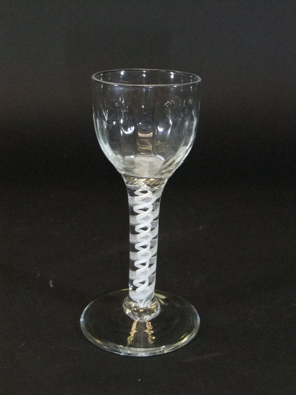 A mid 18th Century wine glass with ogee shaped bowl and wrythen decoration,