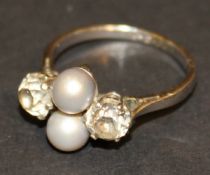 A white gold dress ring set with two grey pearls and two diamonds approx 0.55 carat each, the ring