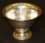 An Omar Ramsden beaten silver pedestal bowl with flared rim raised on a circular stepped base with
