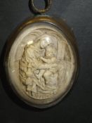 A 19th Century plaster relief work plaque depicting The Virgin Mary and Jesus in an interior scene,