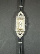 An Art Deco 1930's ladies cocktail wristwatch, the platinum case set with small diamonds,