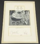 A framed and glazed black and white image of the Royal Family with infant Prince Edward in pram