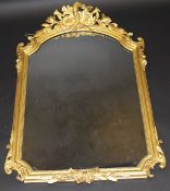 A 19th Century carved giltwood and gesso framed wall mirror with musical instrument decorated