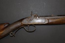 A 19th Century muzzle loading carbine with walnut stock and cheek plate,