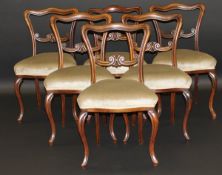 A set of six Victorian rosewood shaped back dining chairs with green velvet upholstered shaped