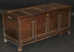 An 18th Century oak coffer, the rectangular four panel top above four further front panels,