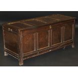 An 18th Century oak coffer, the rectangular four panel top above four further front panels,