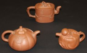 A Yixing terracotta teapot in the form of a gourd, bears impressed circular mark to base,