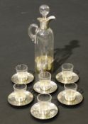 An Edwardian cased silver and glass liqueur set comprising 6 shot glasses and saucers,