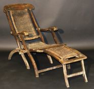 An early 20th Century teak and caned folding deck lounger chair,