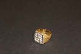 An 18 carat gold gentleman's dress ring set with twelve diamonds, approx 0.1 carat each (i.e.