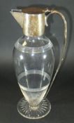 An Edwardian silver mounted cut glass claret jug of simple form (by William Hutton & Sons, London