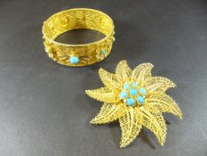A gold filigree work and turquoise decorated bangle, together with a similar leaf decorated brooch,