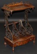 A Victorian rosewood serpentine fronted whatnot with three quarter galleried top with vertical