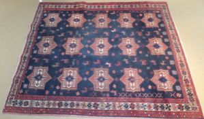 An Afghan tribal rug, the centre field with repeating star medallions in red,