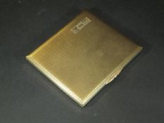 A 9 carat gold engine turned decorated cigarette case with foliate decorated handle inscribed "EIM",