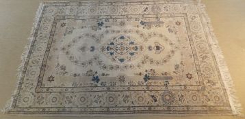 A Kashan rug, the central floral decorated medallion in cream,