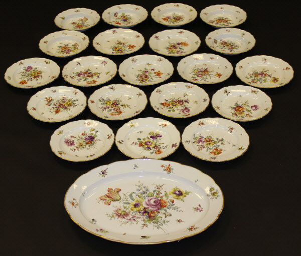 A 20th Century Meissen part dinner service painted with floral sprays and with shaped gilt decorated