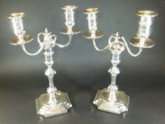 A pair of Victorian silver two branch candlesticks (by Hawksworth, Eyre & Co. Ltd., Sheffield 1891),