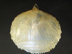 A carved mother of pearl plaque depicting religious scene,