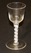 A late 18th Century wine glass with ogee shaped bowl, the stem with spiral tapes to plain foot, 14.