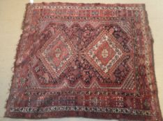 A Qashqai rug, the two central diamond shaped medallions in red, cream,