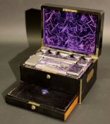 A late Victorian coromandel travelling vanity case containing various cut glass and silver mounted