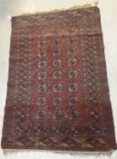 A Bokhara Tekke rug, the centre field with repeating elephant foot medallions in cream,