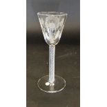 A mid 18th Century wine glass, the bowl as a round funnel with engraving of two rose buds,