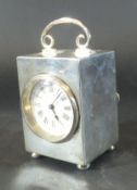 An Edwardian silver carriage clock with swing handle to top,