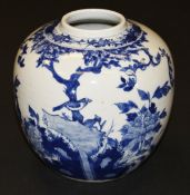 A Chinese porcelain ginger jar painted in underglaze blue with birds amongst blossoming branches and