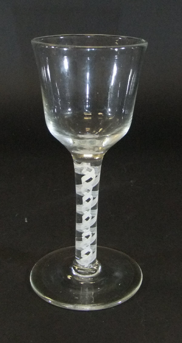 A mid 18th Century wine glass with ogee shaped bowl,