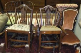 Two dark elm Ercol stick back armchairs (no cushions), together with two mahogany dining chairs