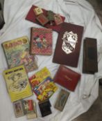 A box of various games and toys including cards, draught, etc.