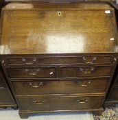 An 18th Century oak bureau, the fall front opening to reveal various drawers, pigeon holes,