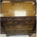 An 18th Century oak bureau, the fall front opening to reveal various drawers, pigeon holes,