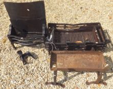 A large cast iron fire grate and ash pan, two cast iron fire dogs,
