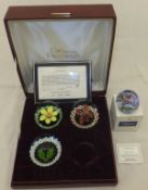 A collection of four Caithness glass paperweights comprising three of the "Four Seasons", designed