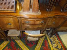 A reproduction mahogany serpentine fronted sideboard, a Victorian walnut low salon chair,