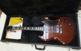 A Gibson SG electric guitar, cherry finish, Serial No. 180768, stamped to rear of head stock and