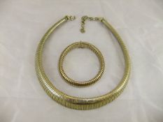 A 9 carat gold bracelet, together with a similar Christian Dior yellow metal necklace CONDITION