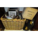 A large wicker basket containing an assortment of various sundry items to include curtain rail ends,