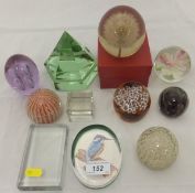 A collection of various glass paperweights,