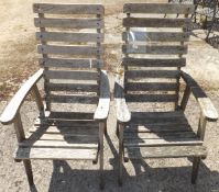 A pair of slatted wood garden chairs