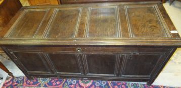 An 18th Century oak coffer, the rectangular four panel top above four further front panels,