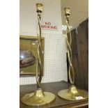 A pair of vintage open twisted brass candlesticks on circular bases