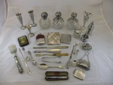 A box containing various silver cutlery, spill vases, silver mounted dressing table bottles,